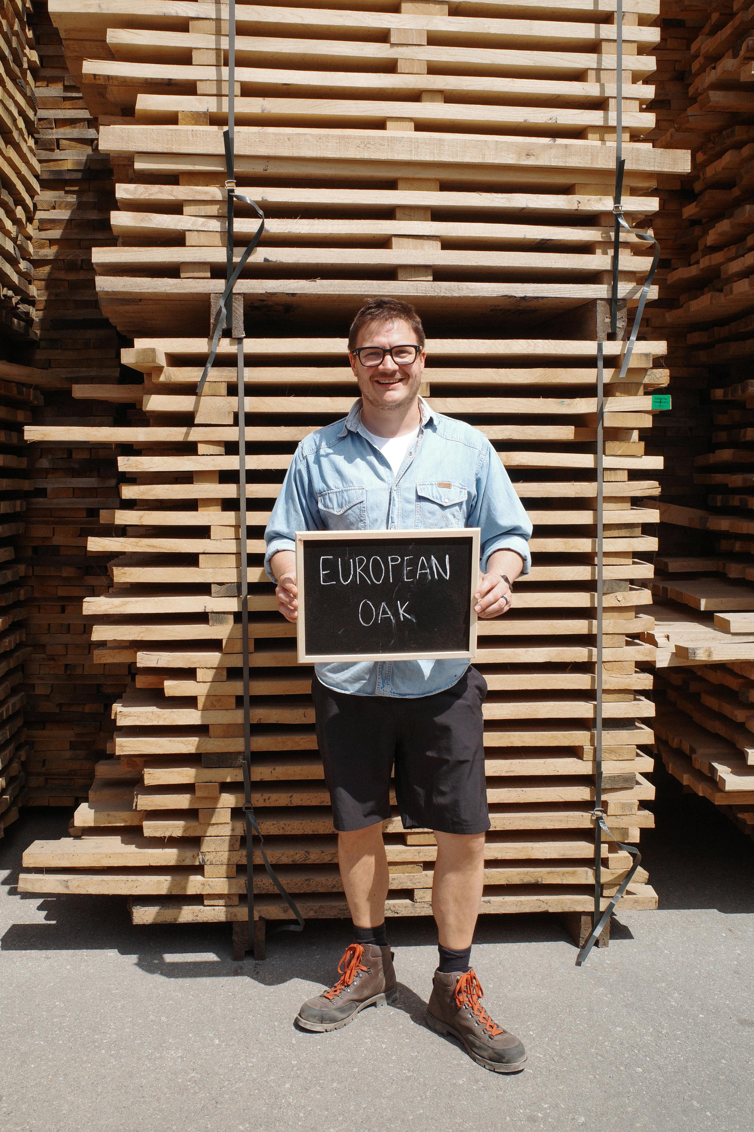 Master Whisky Makers, Marc Watson holding a European oak sign at cooperage in Jerez